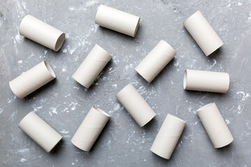 Empty toilet paper roll on colored background. Recyclable paper tube with metal plug end made of kraft paper or cardboard