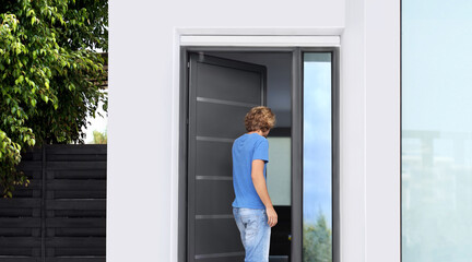 Man opening the door of her home.Inviting the guests