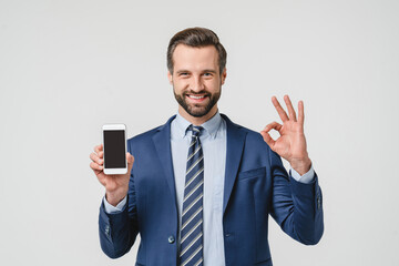 Successful caucasian young businessman ceo boss leader financial adviser using smart phone showing screen for mockup copyspace, online mobile application isolated in white
