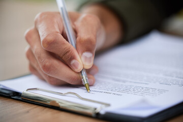 Never overlook the fine print. Closeup shot of an unrecognisable man going through paperwork.
