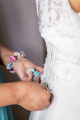 Obraz na płótnie Canvas Bride getting ready, dressing, on her wedding day