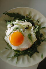 fried eggs with bacon and vegetables