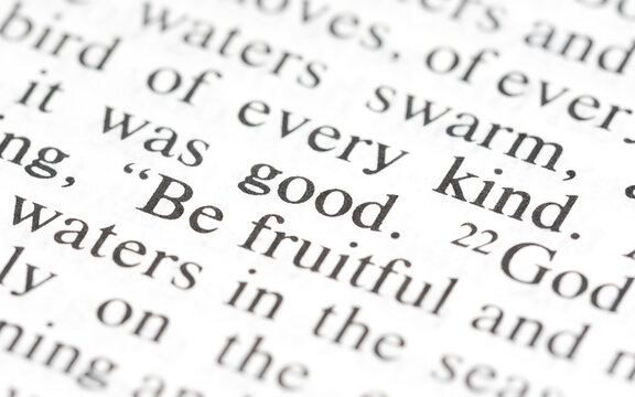 Word good highlighted in the bible text line object detail, macro, extreme closeup, selective focus. Kindness, goodness, doing right good deeds simple concept, ethics religion, philosophy, no people