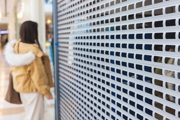 Stores show case in shopping mall closed due to sanctions, boycott and embargo, mass market cloth shops work stoppage with closed storefronts, retail business suspension and brands leaving market