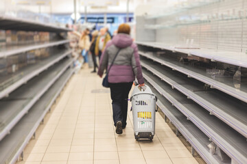 View of empty supermarket shelves, grocery store work stoppage closes, sanctions and embargo, panic...