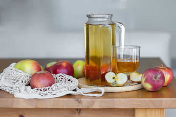 Fresh homemade organic apple juice or cider on a wooden table in a glass jug