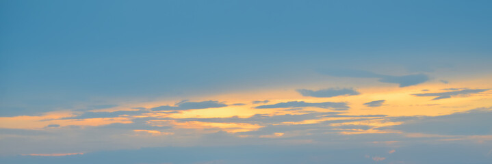 Naklejka na ściany i meble Beautiful evening sky in blue, yellow and orange colors. Sunset sky. Long banner
