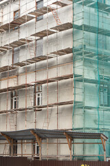 scaffolding outside the house. renovation of an old building.