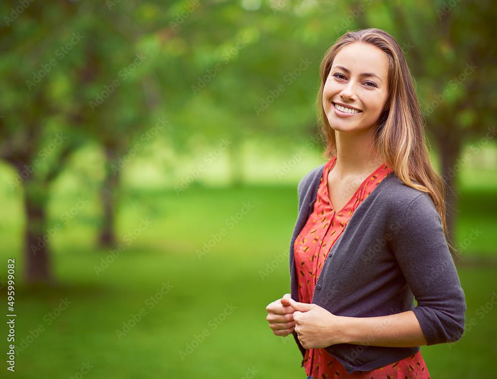 Wall mural Look for the beauty in every day. Portrait of a young woman standing in the outdoors.