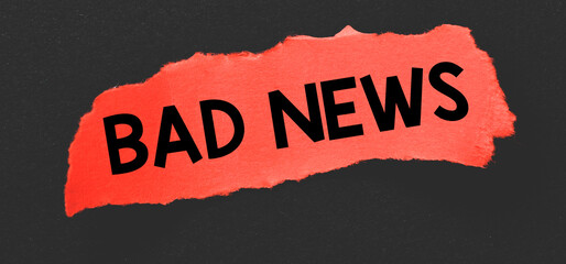 BAD NEWS word written on a red piece of paper.