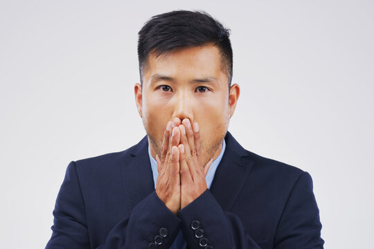 I messed up big time. Studio shot of a young man looking shocked against a grey background.