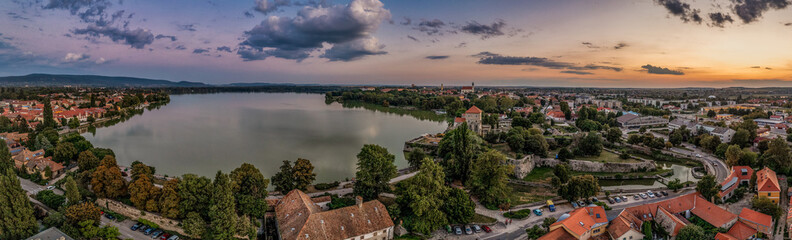 Fototapeta premium Aerial sunset view over the old lake of Tata with medieval castle surrounded by moat, bastions and walls in Hungary