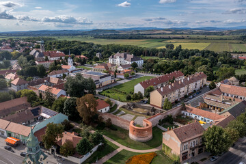 Aerial view of Szecseny in Nograd county Hungary with walled medieval center, modern block houses typical Hungarian small town