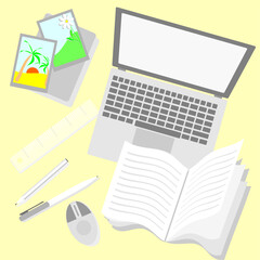 office worker's desk with laptop and stationery