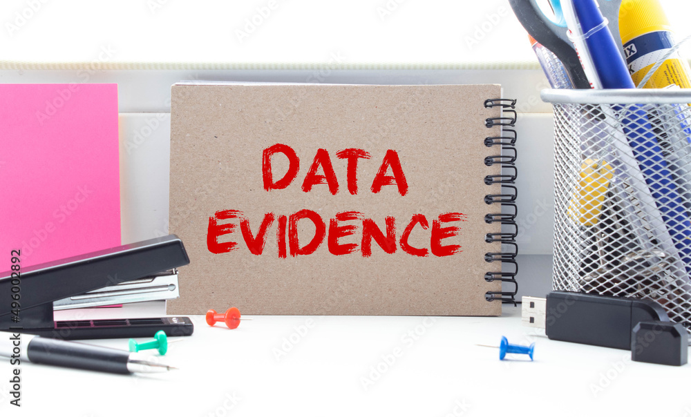 Poster data evidence - business concept, text on a notebook with a spring on a pink background