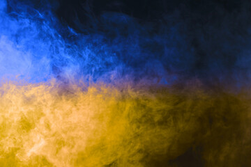 Beautiful smoke in color of Ukrainian flag in the darkness