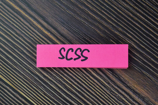SCSS write on sticky notes isolated on Wooden Table.