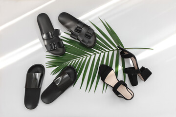 Summer women's shoes. Black heeled sandals, flat sandals, rubber slippers and tropical palm leave...
