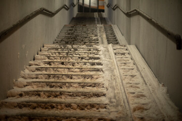 Staircase in snow. Pedestrian crossing across street. Lifting tunnel. Steps up.