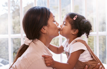 Kisses for my good girl. Shot of a young mother giving her daughter a kiss at home.