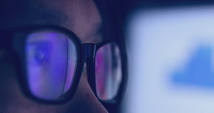 4K video super close up eye ball with eyeglasses reflect coding screen. Background concept for programming and coding computing.