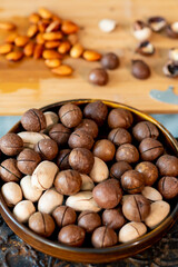 Macadamia nuts in a wooden plate. fitness and diet, healthy lifestyle.