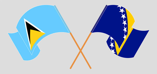 Crossed and waving flags of Saint Lucia and Bosnia and Herzegovina