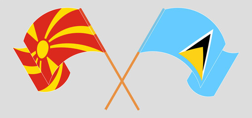 Crossed and waving flags of North Macedonia and Saint Lucia