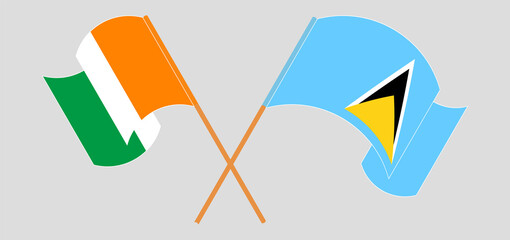 Crossed and waving flags of Ivory Coast and Saint Lucia