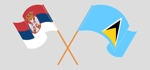 Crossed and waving flags of Serbia and Saint Lucia