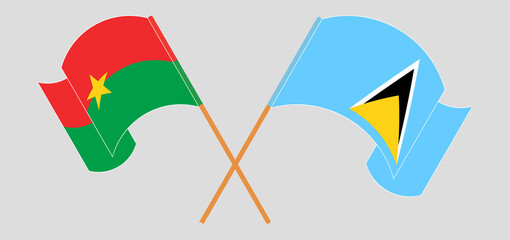 Crossed and waving flags of Burkina Faso and Saint Lucia
