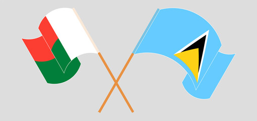 Crossed and waving flags of Madagascar and Saint Lucia