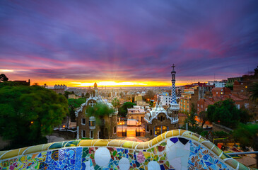 Obraz premium Beautiful sunrise in Barcelona seen from Park Guell. Park was built from 1900 to 1914 and was officially opened as a public park in 1926. In 1984, UNESCO declared the park a World Heritage Site