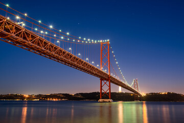 The 25 de Abril bridge at dusk in Lisbon. Portugal