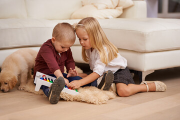 Lets work on our string theory proof. Two young children playing with an abacus.