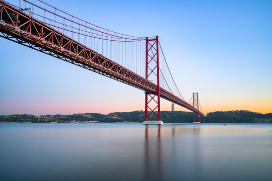 The 25 de Abril bridge at sunset over the Tajo River in Lisbon. Portugal