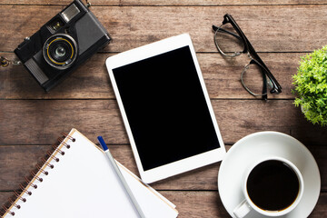 Tablets on coffee and notebook