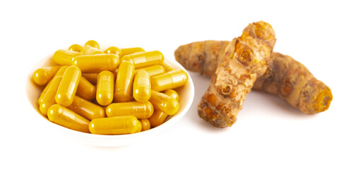 Ground Turmeric in Capsule form on a White Background