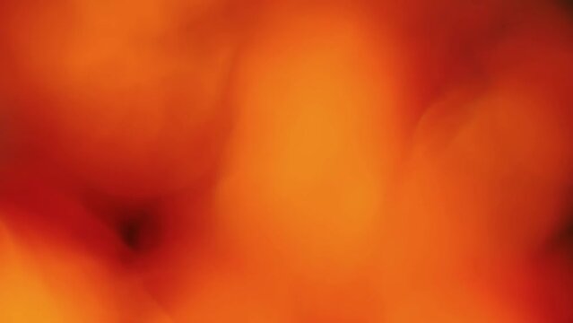 Static view of a defocused shimmering red fire with smoke