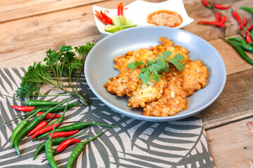 Corn Fritters With chili sauce placed on a wooden table