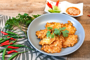 Corn Fritters With chili sauce placed on a wooden table