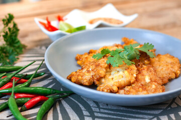Corn Fritters With chili sauce placed on a wooden table