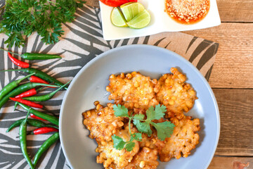 Corn Fritters With chili sauce placed on a wooden table