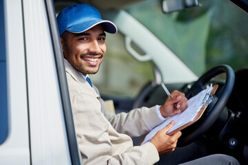 All his deliveries are running smoothly. Portrait of a happy delivery man driving his van.