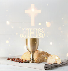 Chalice of wine with bread and rosary beads on light background. Holy Communion concept