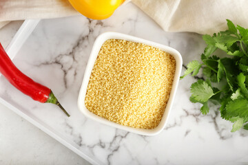 Bowl of raw couscous on tray