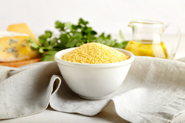Bowl of raw couscous on table
