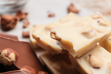 Pieces of tasty chocolate with hazelnuts, closeup