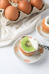 Kiwi cupcake with butter cream. Sweets or Cupcake with Topping. Birthday Confectionery Dessert, Pies, Pastry, Bakery or Patisserie Production