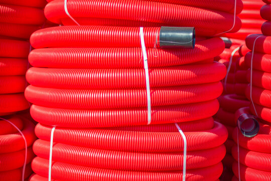 Red plastic pipes are coiled